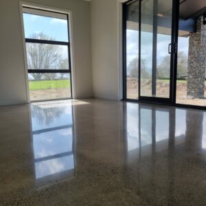 salt and pepper finish for a polished concrete floor photo of salt and pepper polished concrete floor in lounge area looking towards windows with reflection