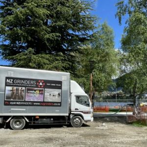 Queenstown lake front path surface walkway 1 NZ Grinders truck in front of a lakefront in queenstown
