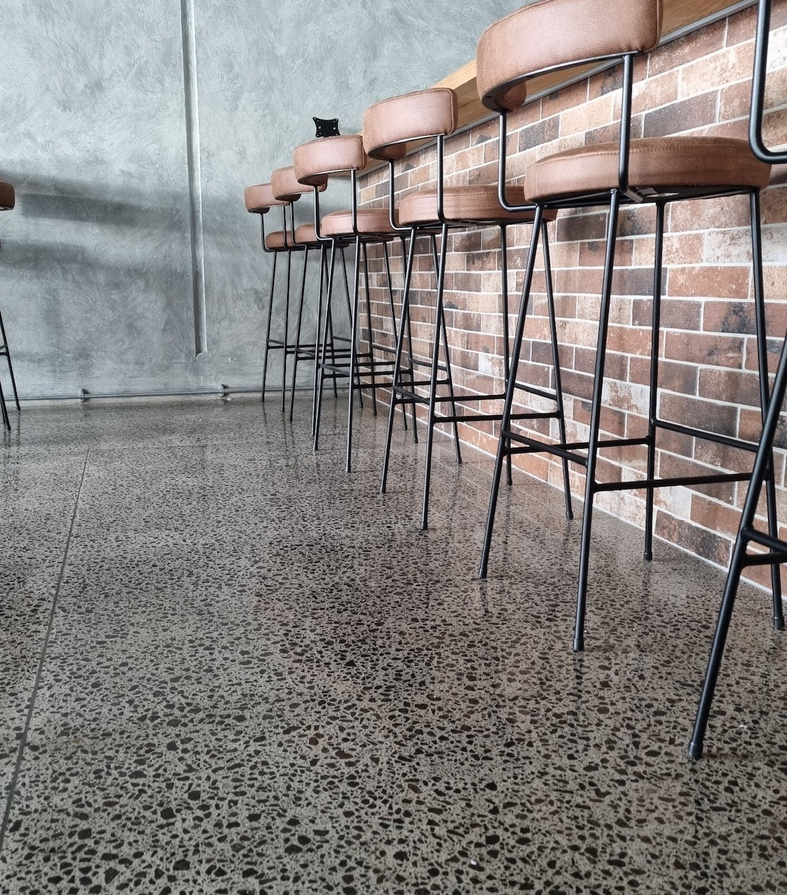 full stone medium gloss polish concrete Full stone exposure floor image at saltwater restaurant floor high gloss mt maunganui