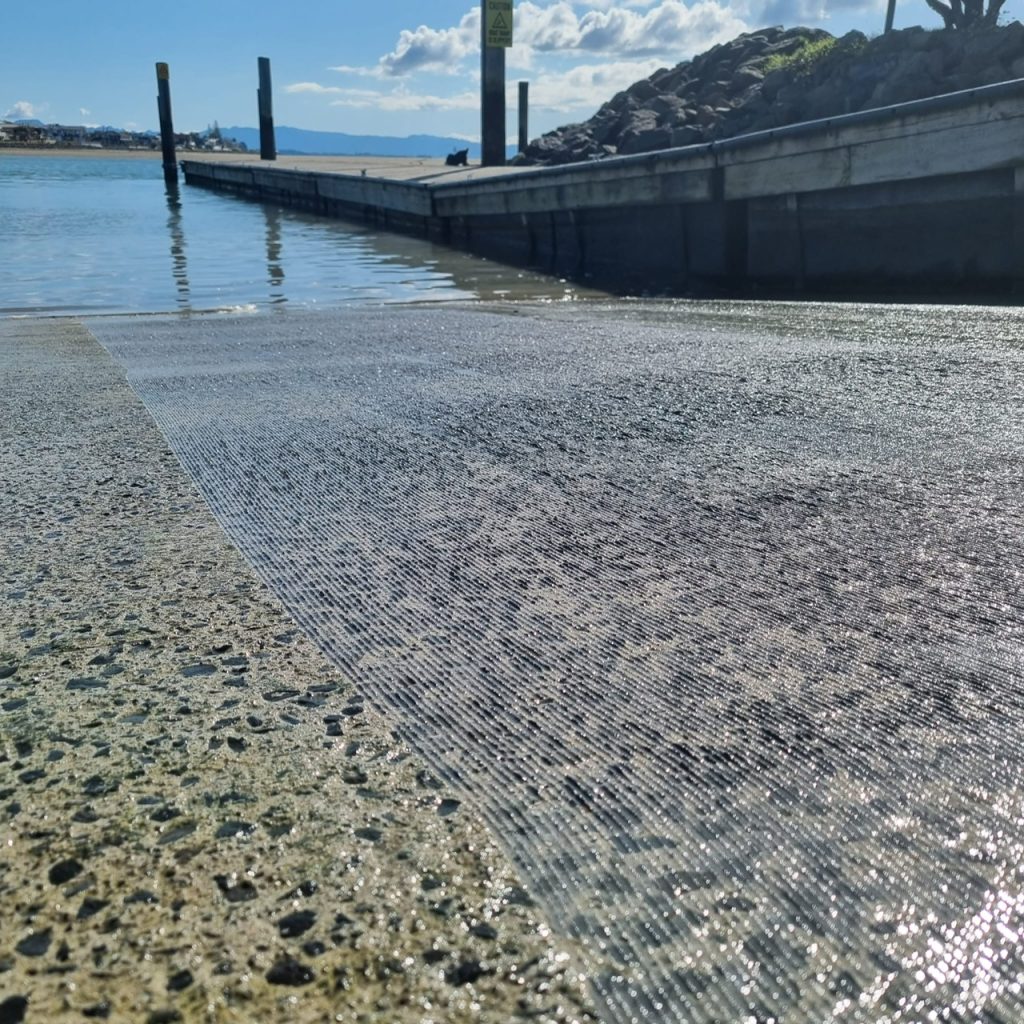 concrete chasing-planer-channel-cutter-boatramp-texture-non-slip Close up side by side image of a concrete boat ramp with before and after channel cutting planing