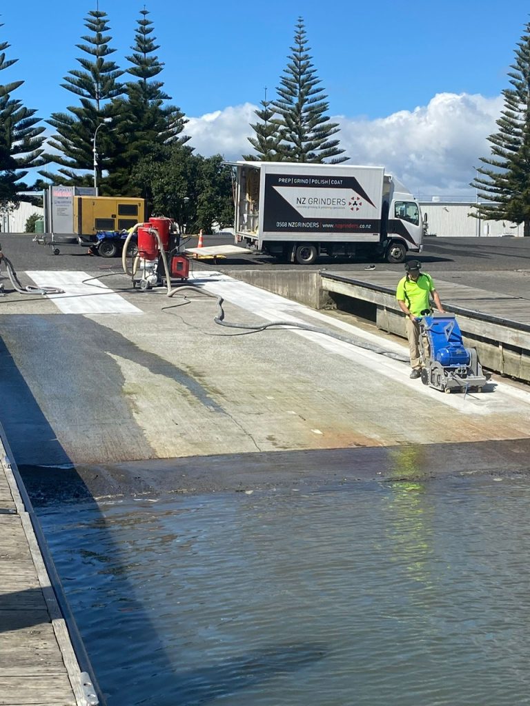 concrete-planer-channel-cutter-boatramp-texture-non-slip A concrete planer machine working on a boat ramp to add texture to concrete for non-slip