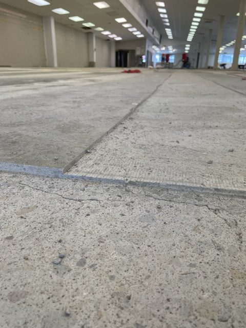 concretes planer blastrac 335 wellington bunnings seismic strengthening close up of concrete floor with 2 levels of cut in a channel - 6mm and 15 mm deep