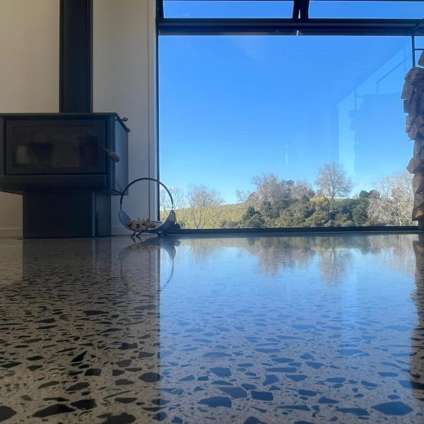 Polished-concrete-floor-lounge-around-fireplace-NZ-Grinder-Tauranga-Queenstown Full stone exposure polished concrete NZ Grinders Tauranga Queenstown