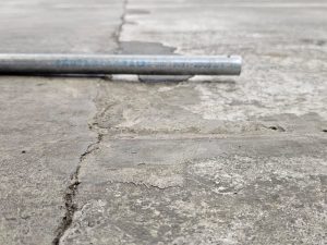1. before heights. Power trowel floor NZ Grinders Tauranga Auckland Damaged concrete floor before